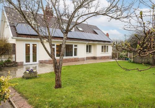 a house with solar panels on the roof at Pared Isaf in Cardigan