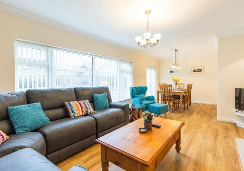 a living room with a couch and a table at Pared Isaf in Cardigan