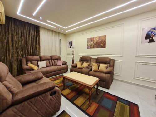 a living room with two couches and a table at RD Served Apartment 3-Bedroom Dokki - Ideal Location Downtown Cairo in Cairo