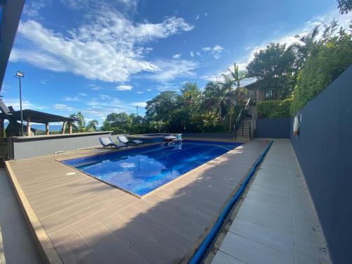 a swimming pool on the side of a house at Finca La Samara in El Higuerón
