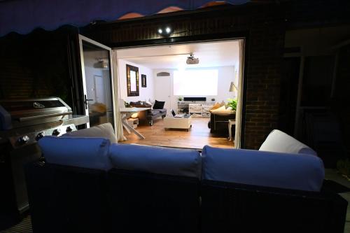 a living room with a blue couch and a living room at 3-Bed House with Amazing Garden in London