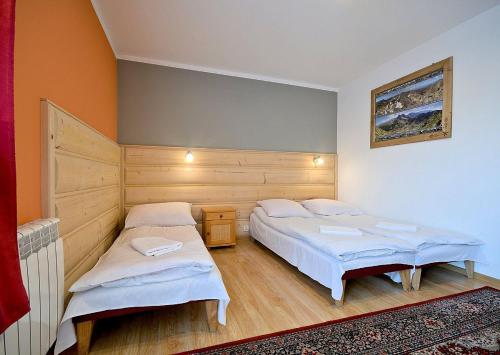 a bedroom with two beds in a room at Dom Wypoczynkowy Skorusa in Białka Tatrzanska