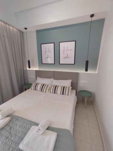 a bedroom with a bed with two towels on it at Dina's Apartment in Vonitsa