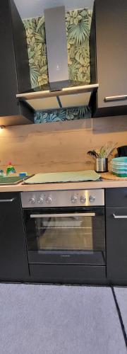 a kitchen with a stove top oven in a counter at Gemütliche Wohnung Kölner Norden in Cologne
