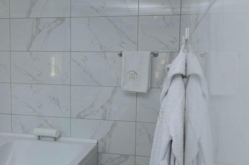a bathroom with a tub and towels on a wall at Spa intimo Višegrad in Višegrad