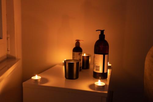 a bottle of wine and two candles on a table at Spa intimo Višegrad in Višegrad