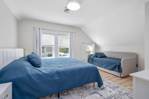 a bedroom with a blue bed and a chair at 232 Wood Road South Yarmouth - Cape State of Mind in South Yarmouth