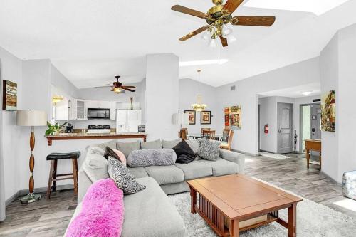a living room with a couch and a table at Tranquil Oasis 4BR Pool Home in Orlando