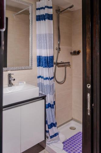 a bathroom with a sink and a shower at Quinta Baião, Douro Valley in Santa Cruz do Douro