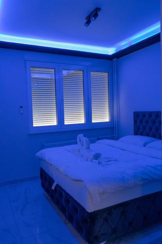 a bedroom with a bed with a blue light at Spa intimo Višegrad in Višegrad