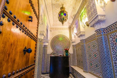 a bathroom with a table in a room with a wall at Riad Sidi Fatah in Rabat