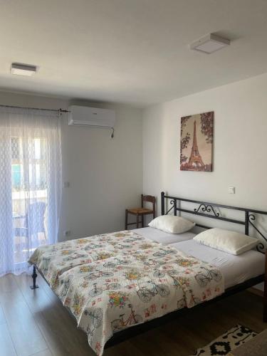 a bedroom with a bed with a quilt and the eiffel tower at Asi 1 i Asi 2 in Ivanica