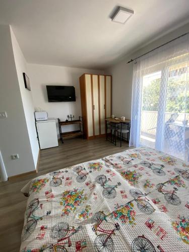 a bedroom with a bed with a bicycle blanket on it at Asi 1 i Asi 2 in Ivanica