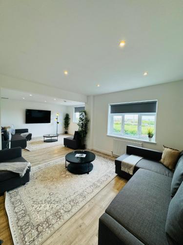a living room with a couch and a tv at The Crescent in Great Yarmouth