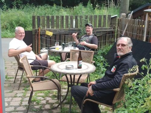 a group of three people sitting at a table at Ruhig und spartanisch Wohnen im Denkmal in Lichtenwalde