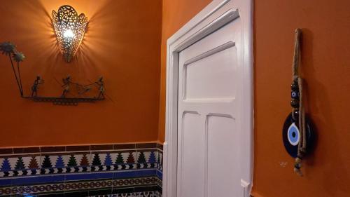 a bathroom with a white door in a room at villazancot in Tangier