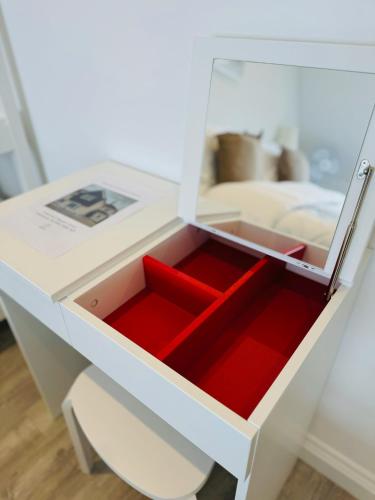 a drawer in a white desk with red inside at The Crescent in Great Yarmouth