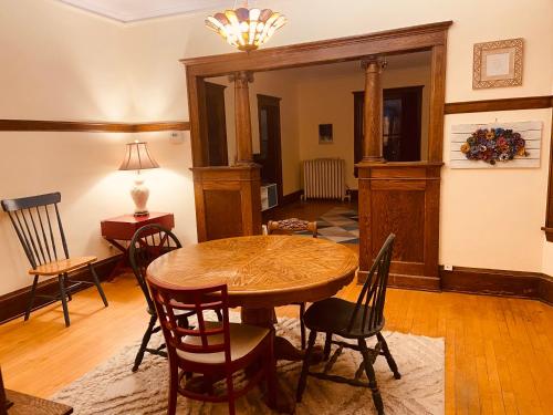 a dining room with a wooden table and chairs at Treetop Apartment in the Heart of MPLS in Minneapolis