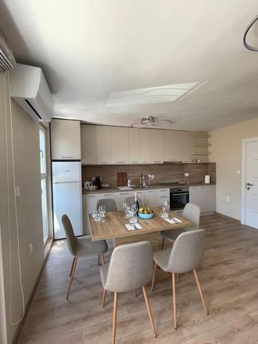 a kitchen with a table and chairs in a room at Comfy home 2 - Burgas Centre in Burgas City