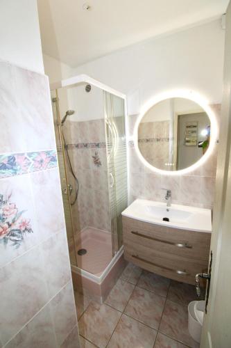 une salle de bain avec une douche, un lavabo et un miroir dans l'établissement Bord de mer, villa 4 chambres, grand jardin, à Martigues