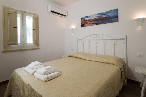 Postel nebo postele na pokoji v ubytování Sotto il Campanile