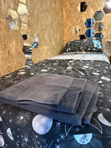 an open book sitting on top of a bed at Eco-friendly beach house in Sesimbra