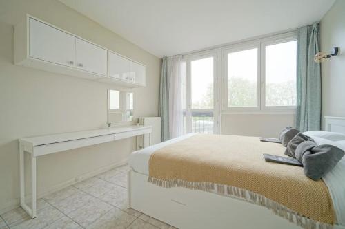 Un dormitorio blanco con una cama y una ventana. en Doorman - Spacious 2BR Paris, en Saint-Ouen