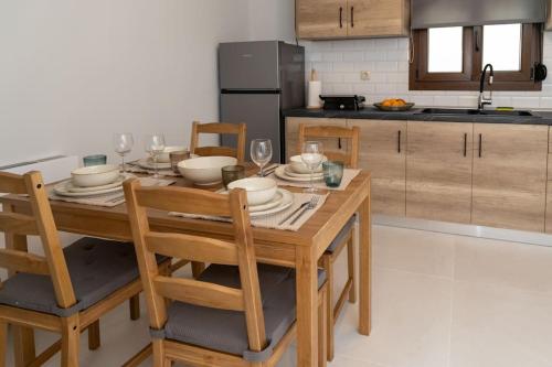 a kitchen with a wooden table with chairs and a dining room at Το Σπίτι της Γιαγιάς 1 (Grandma's House 1) in Kondopoúlion