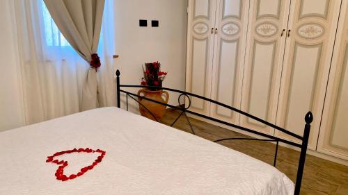 a red heart on a bed in a bedroom at Stone house in Larciano