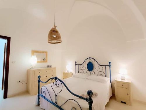 a bedroom with a bed and two night stands at Adelè posto tranquillo al centro del paese in Santa Cesarea Terme