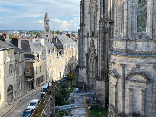 an old cathedral with cars parked on a city street at Bolero in Vannes