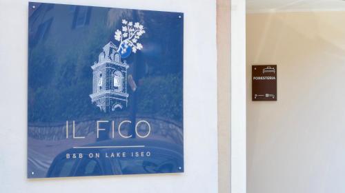 a poster of a clock tower on a wall at Il Fico Lake Iseo b&b in Pilzone