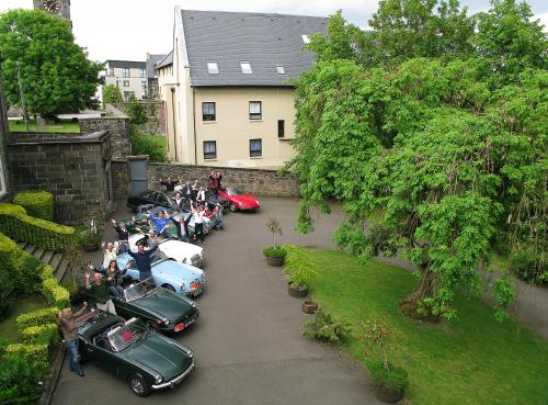 a group of cars parked in a parking lot at Ashtree House Hotel, Glasgow Airport & Paisley in Paisley
