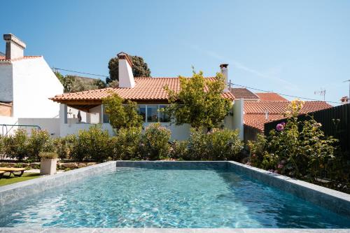 a swimming pool in front of a house at Casa dos Escritores - Casa de Férias com Piscina Privada in Marvão
