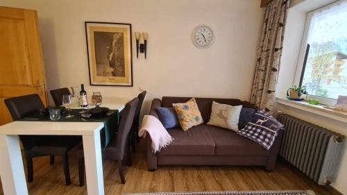 a living room with a couch and a table at Gästehaus Huber in Holzgau