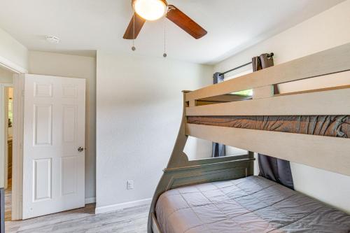 a bedroom with a bunk bed and a ceiling fan at Granbury Home with Lake Views about 6 Mi to Boat Launch! in Granbury