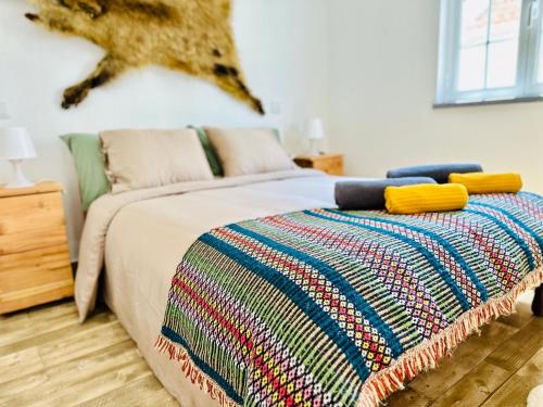 a bedroom with a bed with a colorful blanket on it at Sado Guest House in Alcácer do Sal
