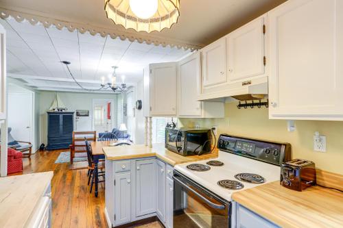 a kitchen with white cabinets and a stove top oven at Walk to Lake Historic Lakeside Marblehead Cottage in Lakeside