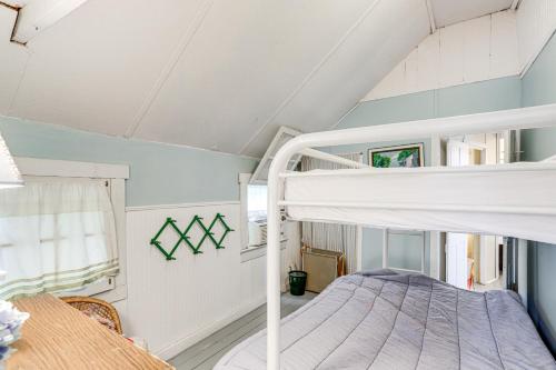 a bedroom with a bunk bed and a table at Walk to Lake Historic Lakeside Marblehead Cottage in Lakeside