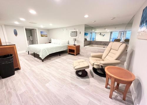 a bedroom with a bed and a couch and a table at Abellona Inn & Suites in Old Orchard Beach