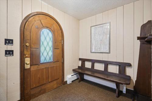 a wooden door and a bench in a room at 4-Bedroom Townhouse with Sauna Snow Flurry in Killington