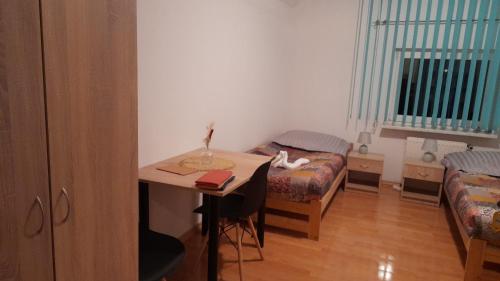 a small room with a table and a bed and a desk at Agro-szyszynka in Jeżów Sudecki