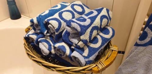 a blue and white towel in a basket on a sink at Villa Bugenvilla in Lokva Rogoznica