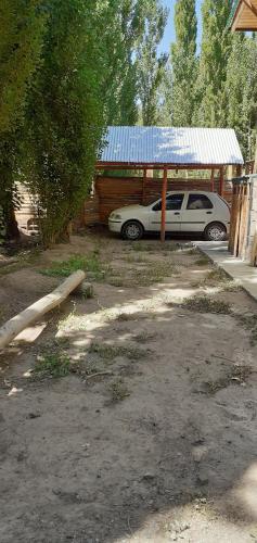 a car parked under a shed with a tin roof at Balcon de Antares in Uspallata