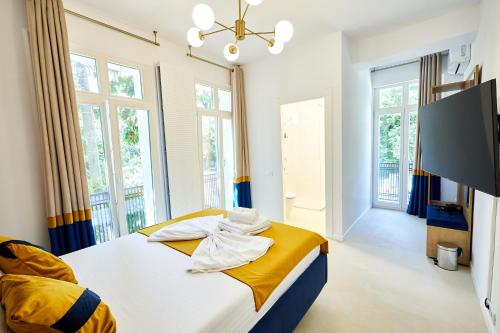a bedroom with a bed with yellow and blue at Carol Park View in Bucharest