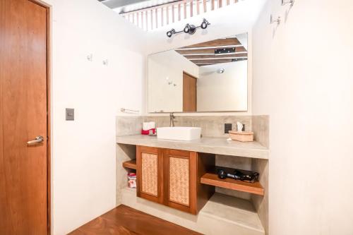 a bathroom with a sink and a mirror at Welcome to Paradise - Luxurious Studio Oasis "Urania" with Pool and Lush Tropical Gardens in Sayulita