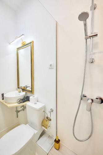 a bathroom with a shower and a toilet and a sink at Carol Park View in Bucharest