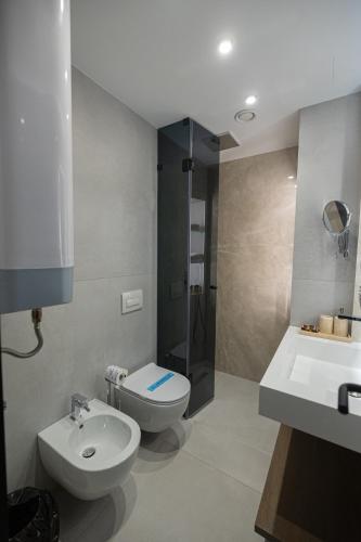 a bathroom with a sink and a toilet and a shower at Diora'S Hotel and Apartments in Vlorë