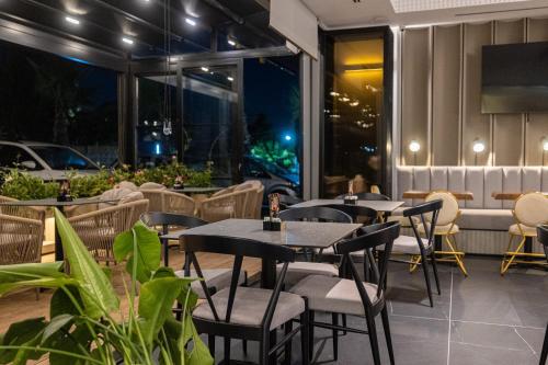 a restaurant with tables and chairs on a patio at Diora'S Hotel and Apartments in Vlorë