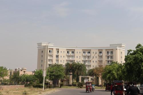 a large white building with a street in front of it at Omaxe Eternity-Near Prem Mandir in Vrindāvan